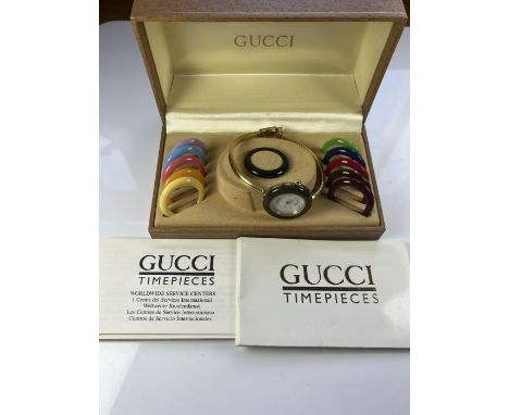 Gucci ladies gold plated watch.&nbsp;model no. 1100-L, a circular white dial with gilt hands and a red &amp; green plastic de