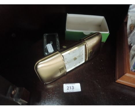An engine turned case Estyma travel clock, inlaid trinket box and brass imp