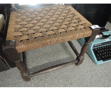 A vintage seagrass seated oak stool