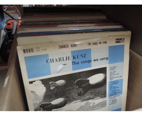 A collection of vintage LP records, including Charlie Kunz
