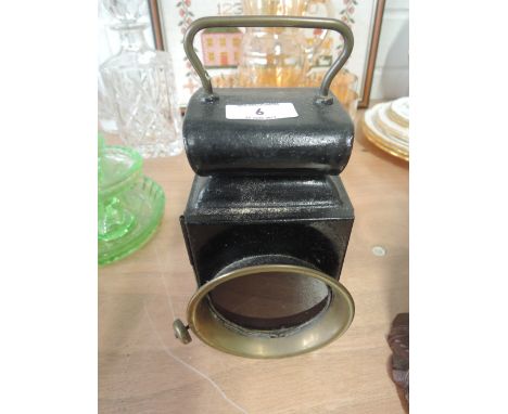 A vintage hand held lamp with a Bartons burner