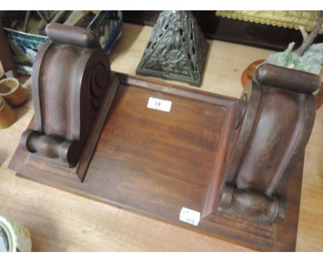 A Mahogany wall shelf with scroll decoration 