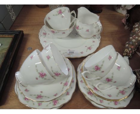 A Royal Osbourne part tea service in white and gilt with pink rose decoration (16 pieces approx)