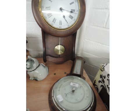 An oak framed barometer/thermometer and wall clock
