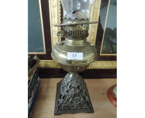 A brass oil lamp on a cast base