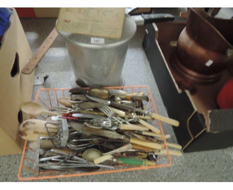 A vintage pioneer pressure cooker and selection of flatware