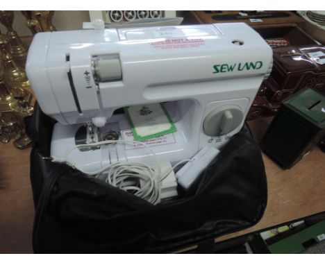 An Sewland compact sewing machine and bobbin box