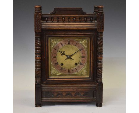 Winterhalder &amp; Hofmeier German oak cased mantel clock, having a silvered chapter ring Roman dial with cherub mask spandre