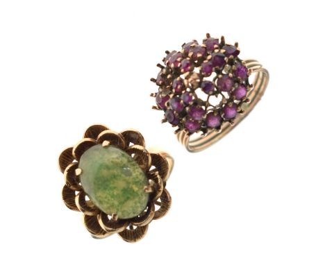 Green hardstone and yellow metal dress ring, the oval cabochon within stylised yellow metal petals, stamped '18K', size Q app