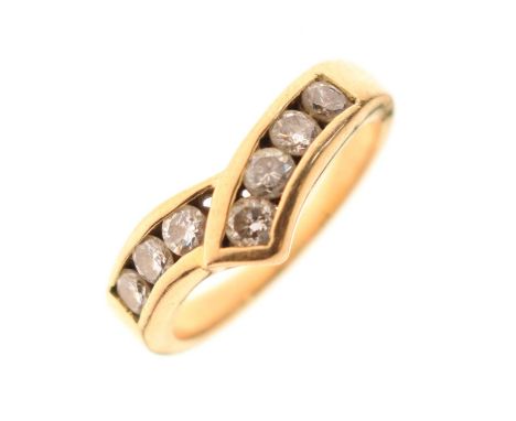 Unmarked yellow metal seven-stone diamond ring, of wrap-over wishbone design, size K approx, 4.5g gross approx