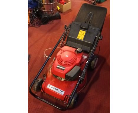A Honda GV100 petrol driven rotary lawn mower. 