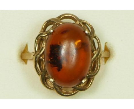 A 9ct gold mounted amber dress ring, R 1/2, 2.5gm 