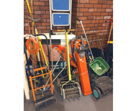A collection of garden tools and equipment to include a Flymo Vac, Flymo strimmers, electric and manual lawn mowers, seed spr