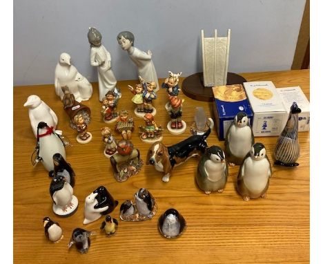 A collection of eight Goebel figurines, together with a Goebel ceramic limited edition symbol in commemoration of the Berlin 