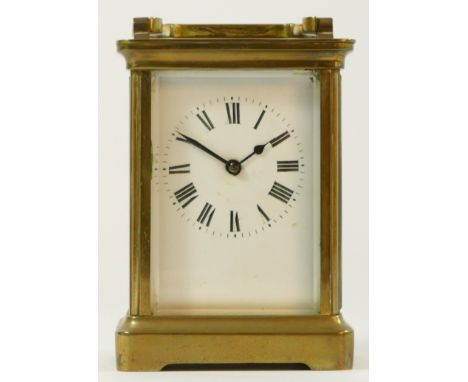 A brass cased 8 day carriage clock, enameled dial with Roman numerals - 12cm tall. 