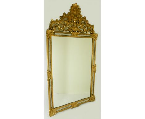 A carved gilt wood ornate over mantle mirror with pierced surmount - 124cm x 67cm.
