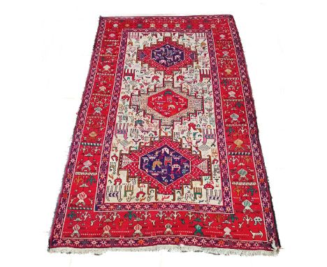 A Persian rug, The Sumak Kilim control panel set with three medallions depicting brightly coloured stylised animals - 200cm x