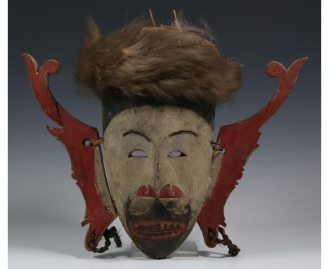   Borneo, Dayak, small wooden face mask, hudoq, with painted paterns and pigments in brown, red and black. With animal hide a