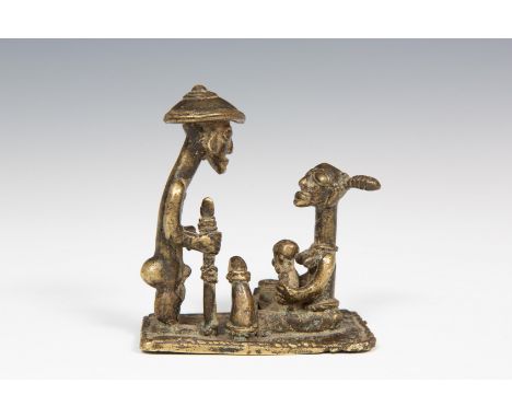   A brass figural group of a Dogon family mother with child and a standing male figure with stick. Private German collection,