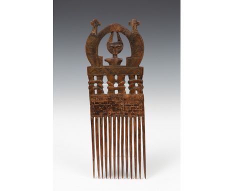   Ghana, Ashante, comb, topped by openworked panel, the half-figure with two horns surrounded by an arch with two crosses. Pr