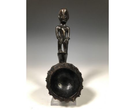   Philippines, Ifugao spoon with a handle in the form of a standing bulul figure. decorated with metal bracelets l. 23,5 cm [