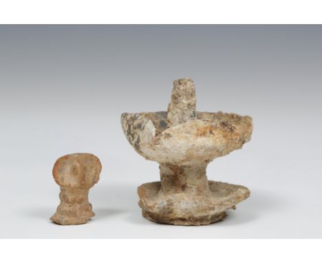   Syria, terracotta bust, 2nd mill. BC and a Roman earthenware oil lamp, 1st-3rd century, with two levels and encrusted patin