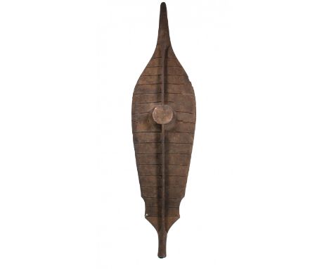   Nias, black lightwooden dance shield, baluse, decorated with tapering carving and horizontal lines of plant fibers, faceted