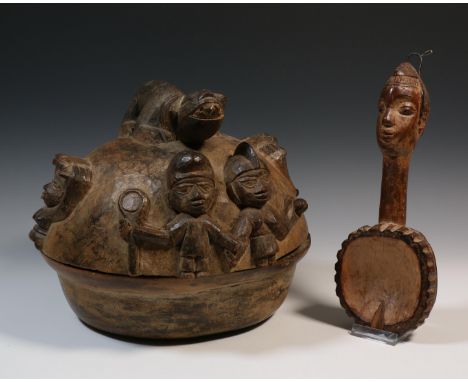   Nigeria, Yoruba, carved wooden kola nut lidded box with in high relief carving of figures and animals and a ceremonial spoo