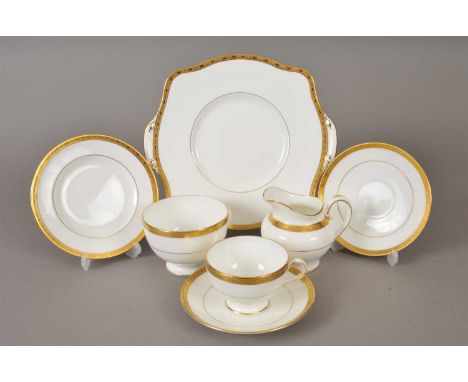 A Minton tea service in the Winchester pattern, K132, decorated in white and gilt, the service comprising twelve teacups, twe