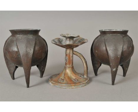 A pair of arts and crafts copper vases, of globular poppy head form with flared rims, on three tapering pointed legs, 19 cm h