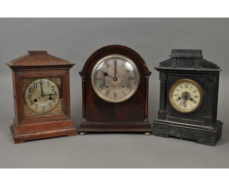 A collection of 19 th and 20 th century cased mantle clocks, in varying architectural and other styled cases together with an