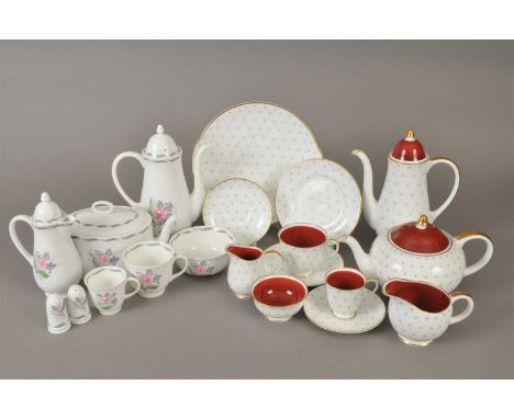 A Susie Cooper tea, coffee and partial dinner service decorated with pink flowers, including coffee pot and cover, teapot and