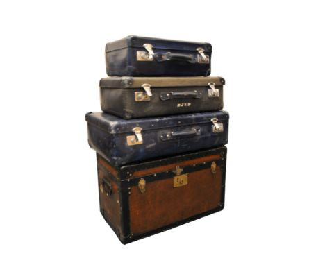 A collection of three 20th century luggage cases, to include three associated graduating blue examples,&nbsp; the largest mea