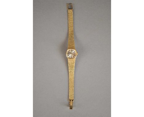 A Ladies 9ct Gold Tissot Watch with integrated bark finish bracelet. Silvered dial and applied gilt baton indices.