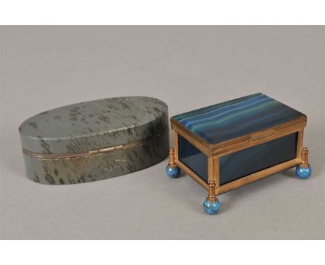 A small 19th century continental blue agate casket, the hinged cover with a bevelled top set within a metalwork frame, raised