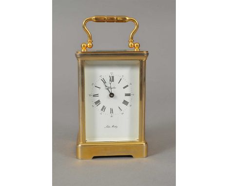 A good quality brass carriage clock, with a white enamelled dial populated with black Arabic and Roman numerals, marked Angel