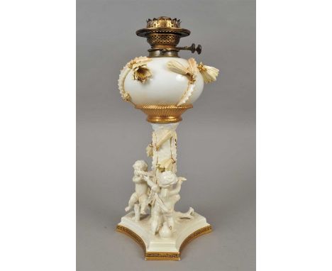 A Victorian Moore Brothers porcelain oil lamp the oval porcelain reservoir applied with yellow trailing flowerheads and gilde