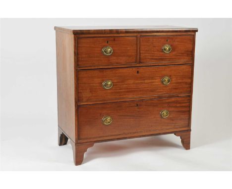 A 19th century mahogany chest of two short and two long cock-beaded drawers, each fitted with brass ring handles presented as