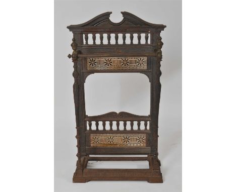 A small Coalbrookdale cast iron framed stick stand, with a broken pediment top above a baluster gallery, flanked with fluted 