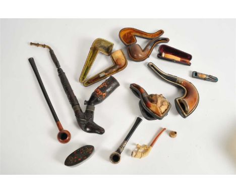 A collection of 19th century meerschaum and other tobacco pipes, to include figural examples, one with a silver collar, toget