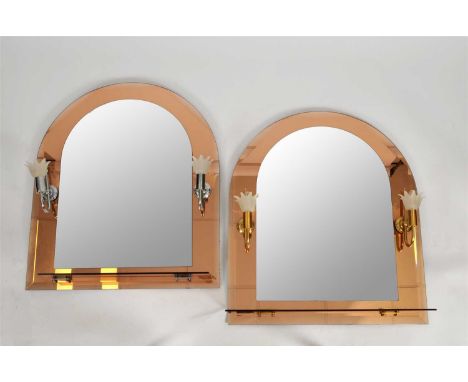 An associated trio of decorative peach glass framed wall mirrors, comprising a pair of arched examples with shaped bevelled p