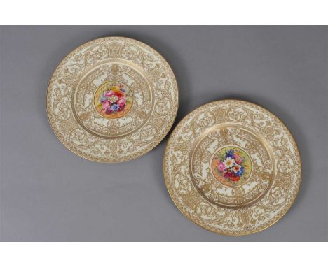 A pair of Royal Worcester cabinet plates dated 1924, centrally painted with bouquets of flowers by E. Phillips and W.H Austin