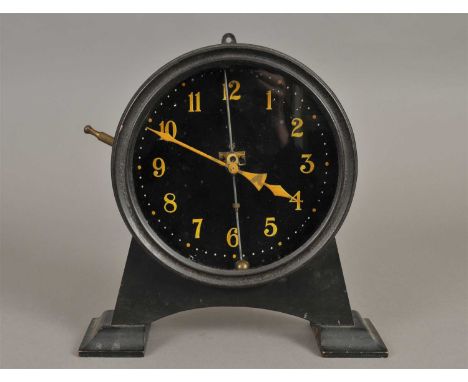 A 20th century gravity clock, with a black ground populated with yellow painted Arabic numerals with original painted hands, 