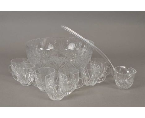A mid-20th century cut glass punch bowl together with seven matching glasses and a glass ladle
