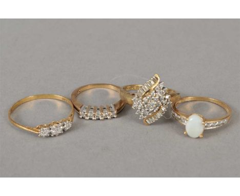 A 9ct gold diamond cluster ring, together with a 9ct gold opal ring, a 9ct gold three stone diamond ring and a 9ct gold five 