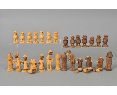 An African export carved wooden chess set and a carved wooden tribal figure.