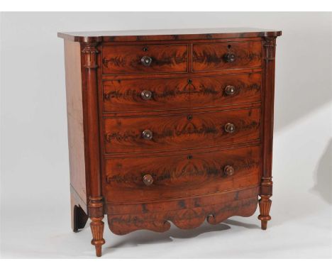 A large Victorian bow fronted mahogany chest of two short and three graduating long drawers, the drawers fitted throughout wi