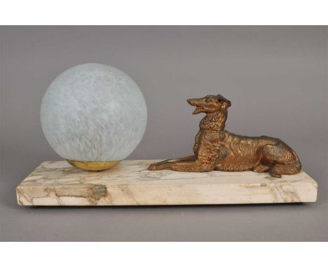 Art Deco desk lamp, a seated spelter hound with a gilded finish beside a mottled globular glass shade (later) raised on a pol