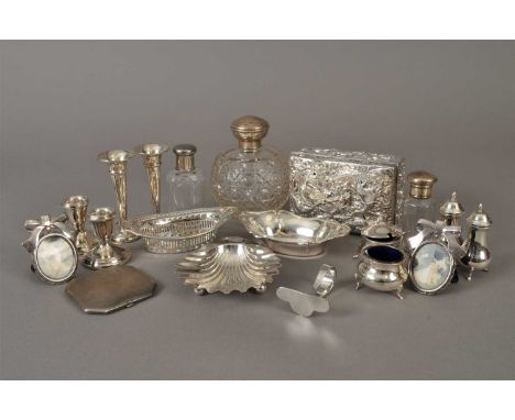 A Goldsmiths &amp; Silversmiths silver butter dish in the form of a shell, together with four silver cruets, two silver pin d