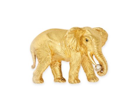 TIFFANY &amp; CO., A VINTAGE DIAMOND ELEPHANT BROOCH in 18ct yellow gold, designed as a standing elephant holding a round bri